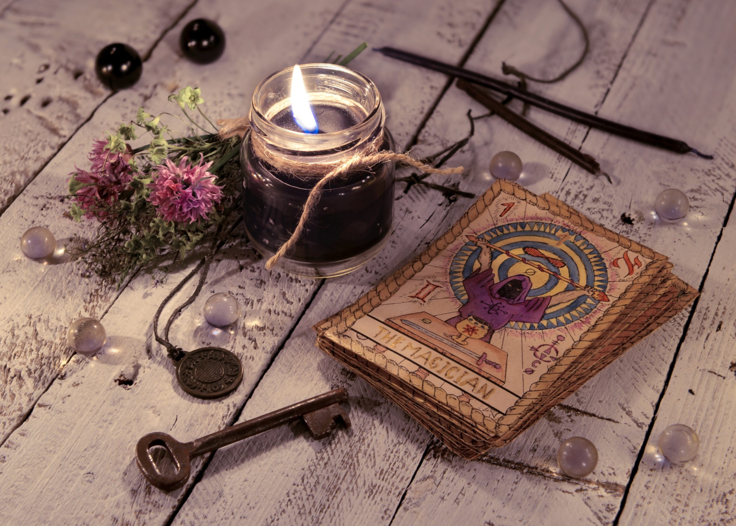 Black,Candle,And,Old,Tarot,Cards,On,Wooden,Planks.,Halloween